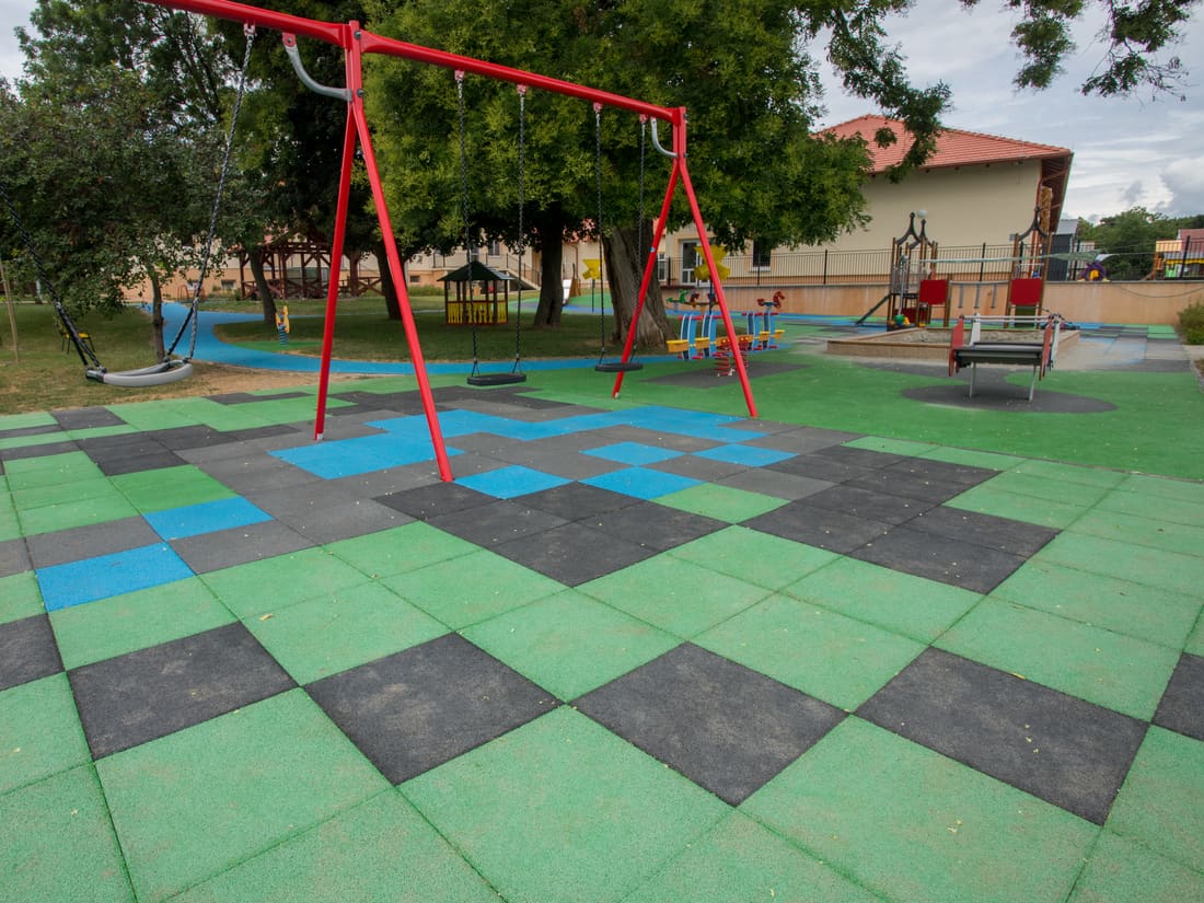 Swing frame on green, blue and grey EPDM tiles
