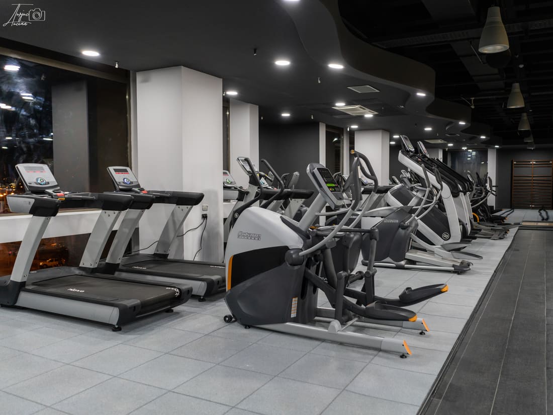 Cardio machines on a dark rubber floor