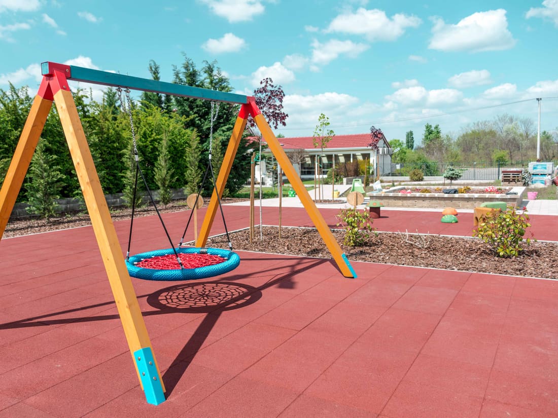 Nest swing on a red rubber tile surface