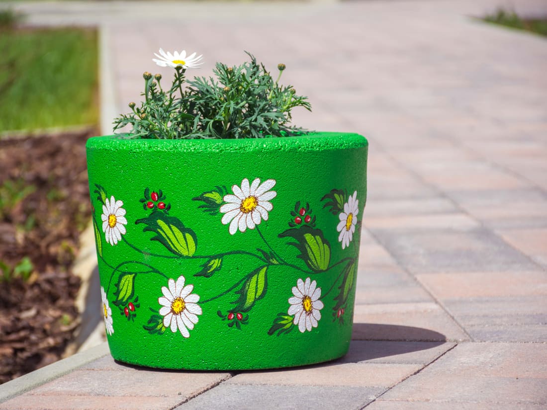 Rubber planter painted with a flower pattern at the edge of the playground