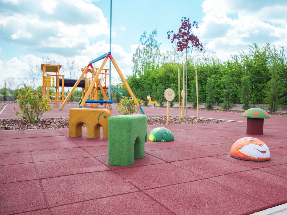 Red rubber tile surface with spring riders