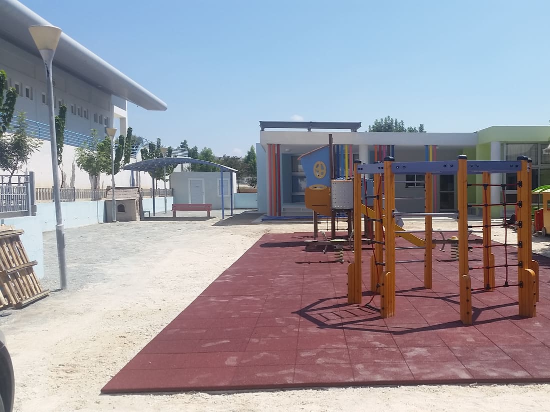 Climbing and exercise frames on red rubber tiles