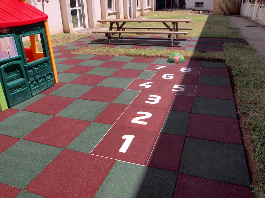 Hopscotch numbers on red and green rubber tiles