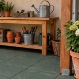 Green rubber tile surface under a garden potting bench