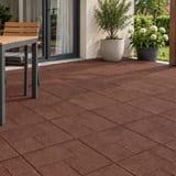 Red-brown rubber tiles on a terrace with garden furniture